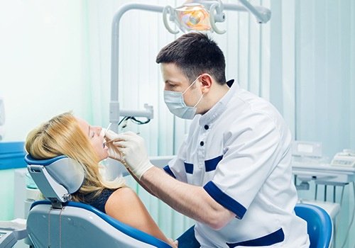 Dentist performing procedure on patient